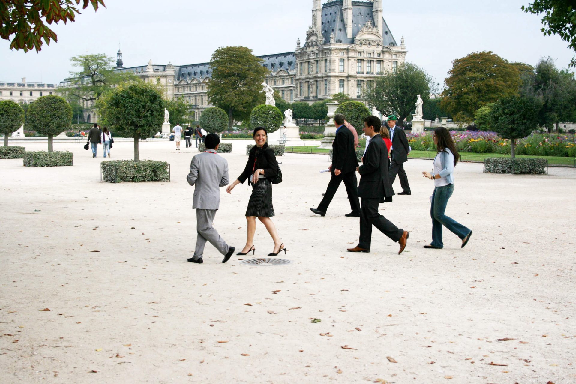 Team building rally, a team crosses the Tuileries Gardens towards the Louvre